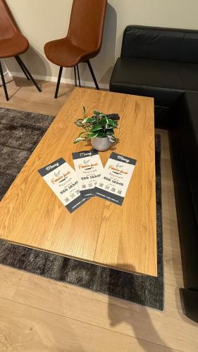 a wooden table with a potted plant on top of it at NesttunPearl in Bergen