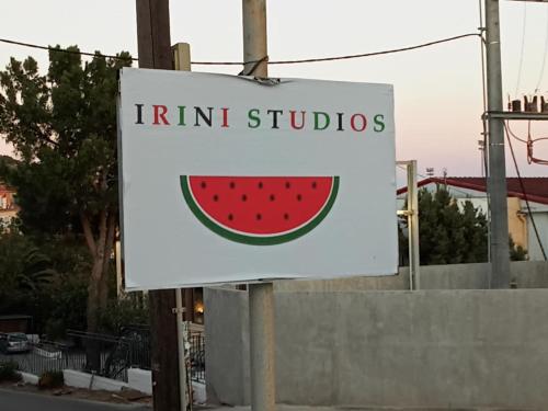 a sign for a fruit studio with a watermelon on it at Irini Studios in Plomari