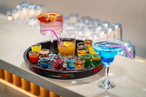 a tray of different types of drinks on a table at Festa Panorama Hotel in Nesebar