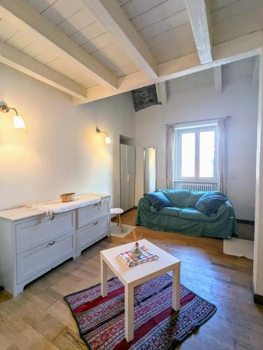 a living room with a table and a couch at Casa Vacanza OXILIA in Domodossola