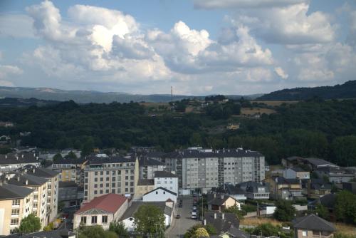 a view of a city with buildings and trees at Albergue EL CASTILLO in Sarria