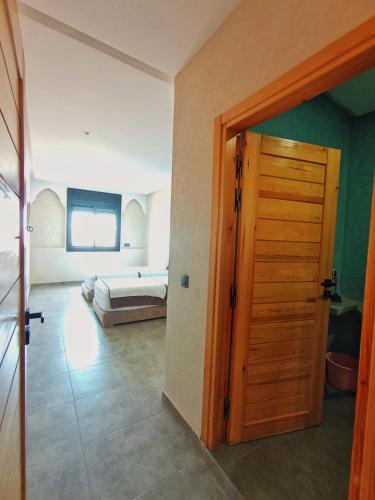 a room with a door leading to a bedroom at Mirleft Horizon Suites in Mirleft