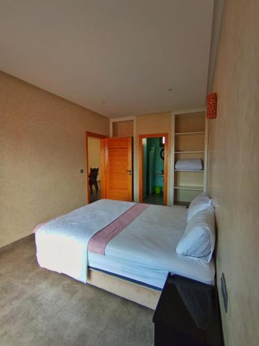 a bedroom with a large white bed in a room at Mirleft Horizon Suites in Mirleft