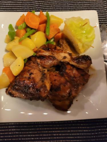 a plate of food with meat and vegetables on it at Sunshine Resort Sigiriya in Sigiriya