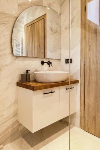 a bathroom with a sink and a mirror at Sivota Apartment SV in Sivota