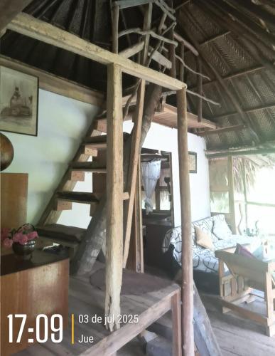 a room with a staircase in a house at Sierra Tayrona hostel in El Zaino