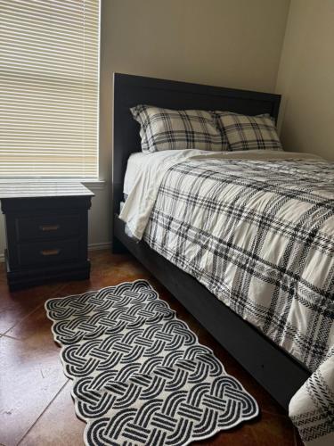 a bedroom with a bed and a rug on the floor at Temora Loop in Killeen