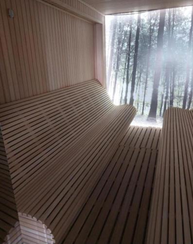a sauna with a window with trees in the background at Una LUX N85 in Kopaonik