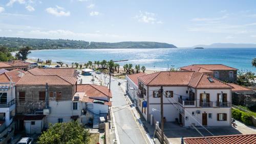 a view of the beach from a town with houses at Mythos Suites-Dionysos apartment in Methoni