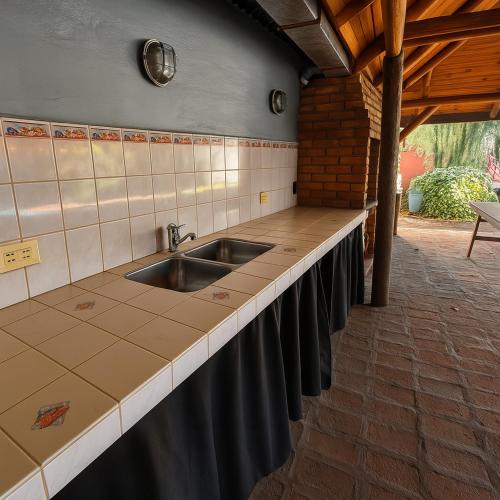 a kitchen with a sink and a counter top at Chalet Ruth's House con pileta in La Cumbre