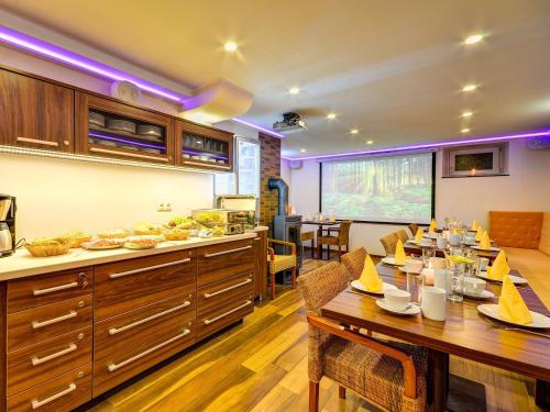a kitchen and dining room with a table and chairs at Apartmány Vila Hedvika in Rožnov pod Radhoštěm