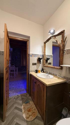 a bathroom with a sink and a mirror at Auberge Alwahabi in Chefchaouene