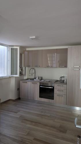 an empty kitchen with a sink and a stove at Il civico storico in Brindisi