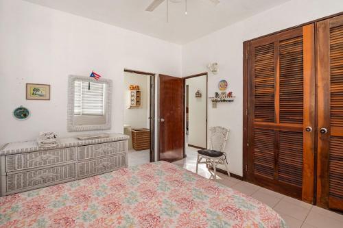 a bedroom with a bed and a desk and a chair at Family House12 Guest Near to Combate Beach in El Combate