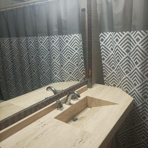 a bathroom with a sink and a mirror at Cabañas Noscohue in Villa General Belgrano