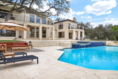 a swimming pool in front of a house at Majestic Oak - Luxury, Billiards Room & Pool in San Antonio