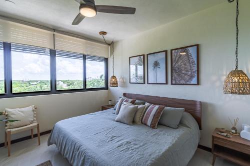 a bedroom with a bed and some windows at Ocean View 2 Bedroom Apartment in Punta Cocos - A201 in Holbox Island