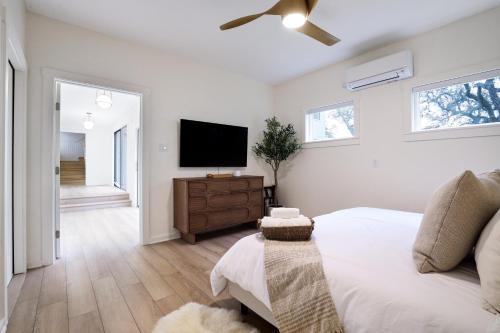 a bedroom with a bed and a flat screen tv at Majestic Oak - Luxury, Billiards Room & Pool in San Antonio