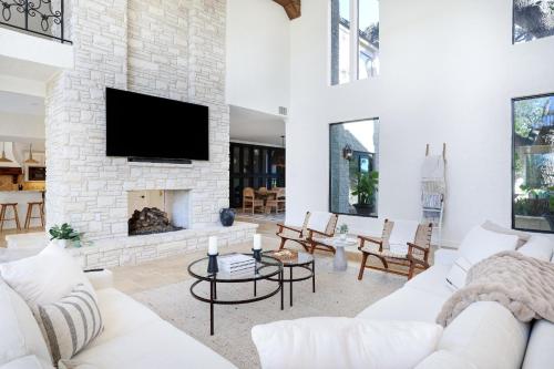 a living room with a fireplace and a tv at Majestic Oak - Luxury, Billiards Room & Pool in San Antonio