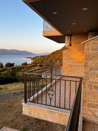 a balcony of a house with a view of the water at Asproneri Elements - Sea View in Kamena Vourla