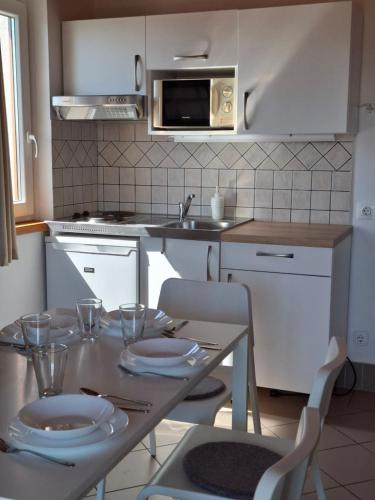 a kitchen with a table with plates on it at Família Apartmanház in Keszthely