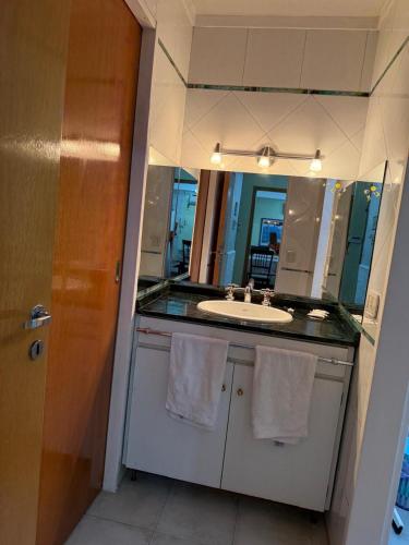 a bathroom with a sink and a mirror at Chalet Buenos Aires in Buenos Aires