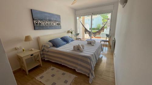a bedroom with a bed with two towels on it at Blue Ocean in Platja  d'Aro