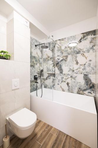 a white bathroom with a toilet and a shower at Vila Zara365 in Zadar