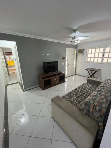 a bedroom with a bed and a flat screen tv at Espaço Shekinah in Araruama