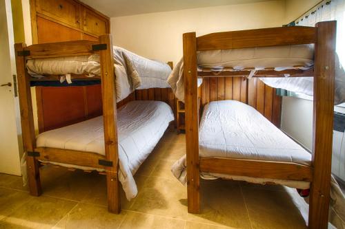 a room with three bunk beds in a room at Refugio Patagonia Hostel in San Carlos de Bariloche