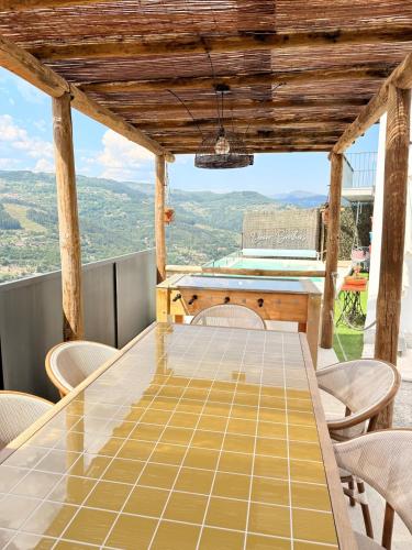 a table and chairs on a balcony with a view at DOURO BROTHERS in Resende