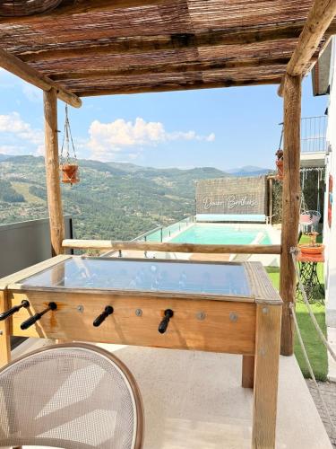 a hot tub on a patio with two chairs at DOURO BROTHERS in Resende