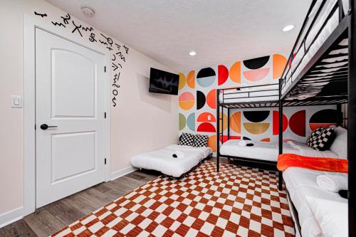a bedroom with two bunk beds with a checkered floor at indy dreamhouse lux stay in Greenwood