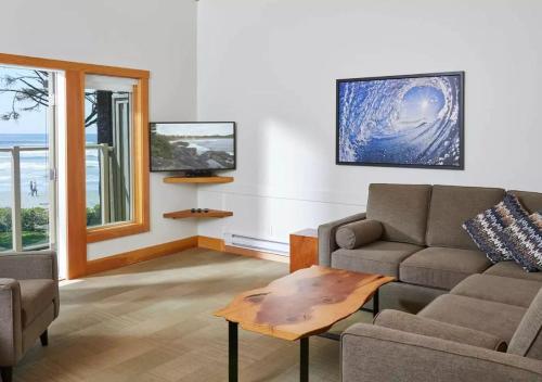 a living room with a couch and a table at Pacific Sands Beach Resort in Tofino