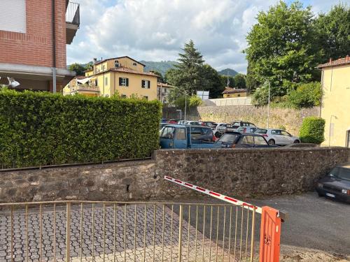 a parking lot with a bunch of parked cars at A due passi dal centro in Barga