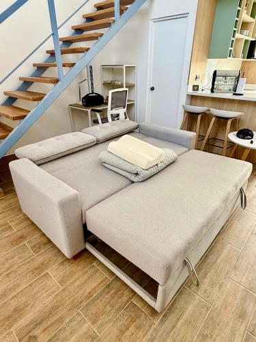 a room with three beds and a staircase at Tiny House con Piscina Privada, AC and Starlink in Paracas