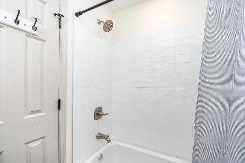 a white bathroom with a tub and a shower at Pickleball - 2 Master Suites - Fire Pit - Game Rm in Nellysford