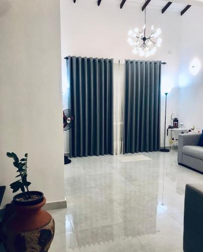 a living room with green curtains and a couch at Millennium Elite in Opata