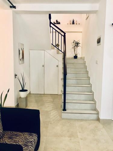 a staircase in a living room with a couch at Millennium Elite in Opata