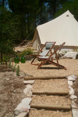 a chair sitting in front of a tent at Quinta da Paz Eco-Lodge in São Luis