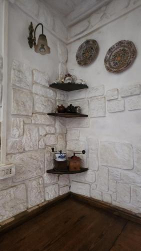 a room with a stone wall with plates and shelves at Casa Alfonsina in Veccialone