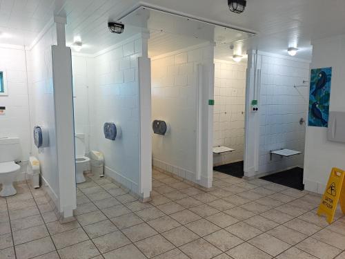 a bathroom with two toilets and two sinks at Whatuwhiwhi TOP 10 Holiday Park in Tokerau Beach