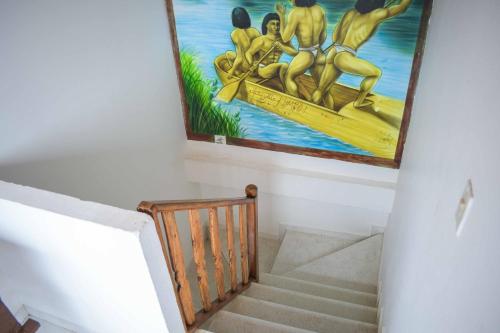 a staircase with a painting of men on a boat at Hotel Majestic plaza in Mompós