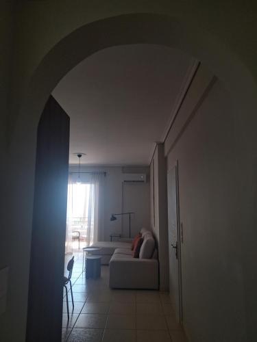 a living room with a couch and a window at Noma apartment in Gythio
