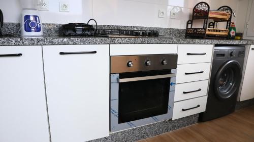 a kitchen with a stove and a dishwasher at CASA DEL TITO in Oulad Akkou