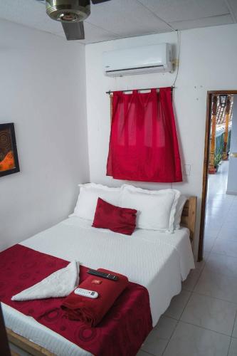 a bedroom with a bed with a red window at Hotel Majestic plaza in Mompós