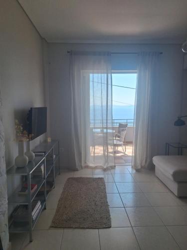 a living room with a view of the ocean at Noma apartment in Gythio