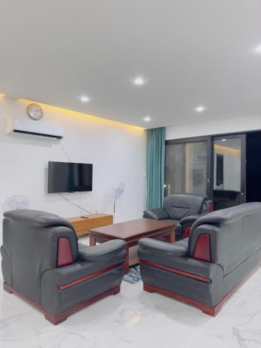 a living room with three leather chairs and a table at Golden Palm Apartment with overlooking view in Port Vila