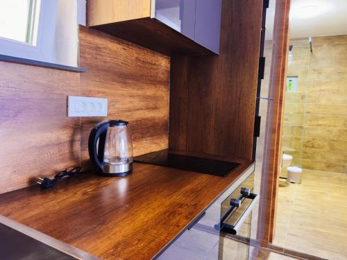 a coffee maker on a wooden counter in a kitchen at TaNa's Apartments in Donji Štoj