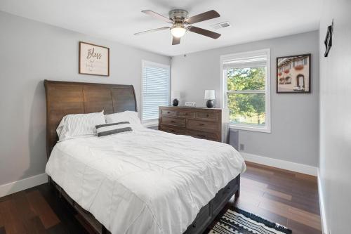 a bedroom with a bed and a ceiling fan at Green Meadow Cabin in Murfreesboro